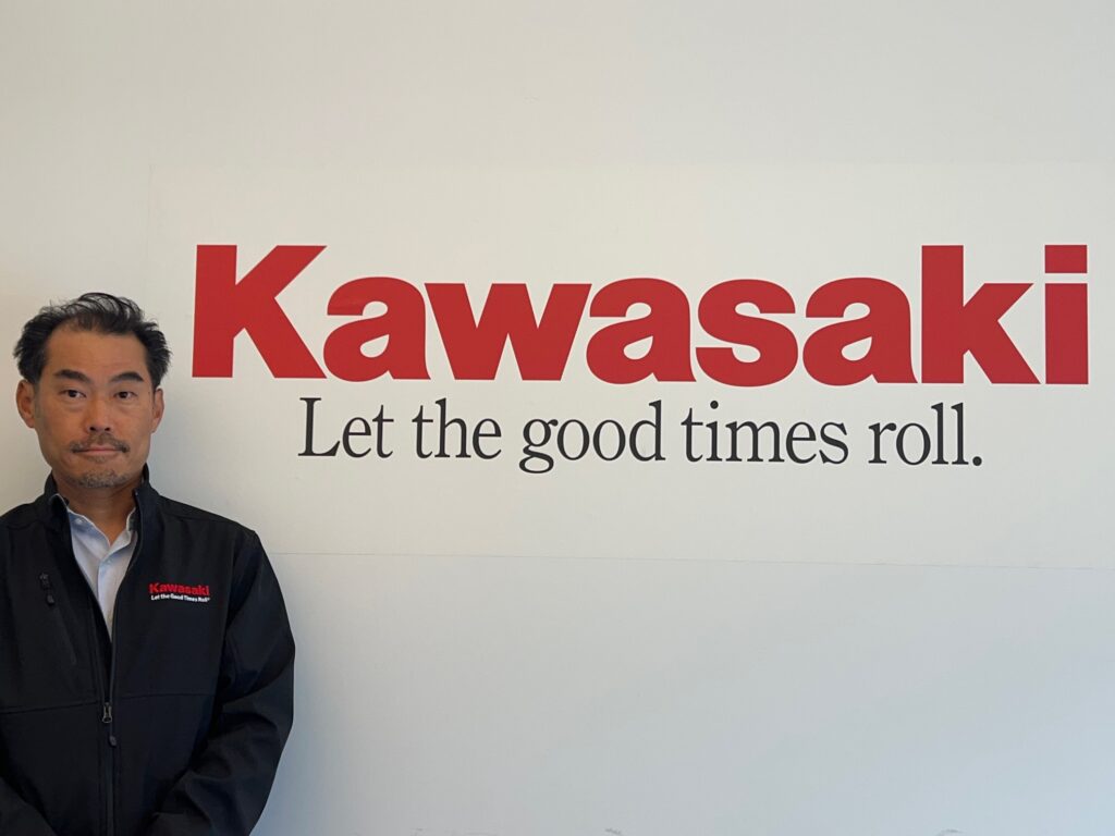 Kawasaki logo and a man 